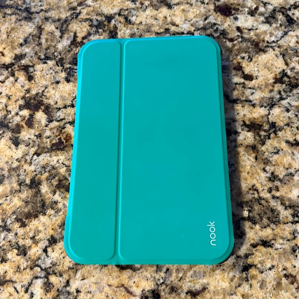 Nook reader with green case and charger cord